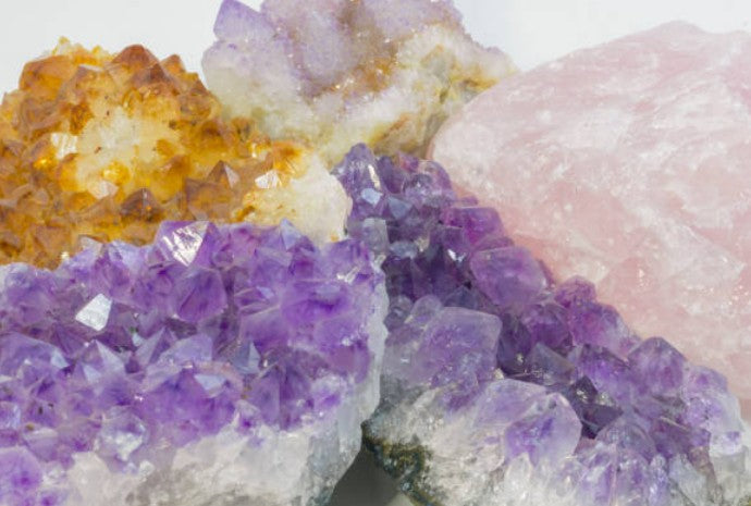 Raw crystal clusters and unpolished natural stones at Quartzed