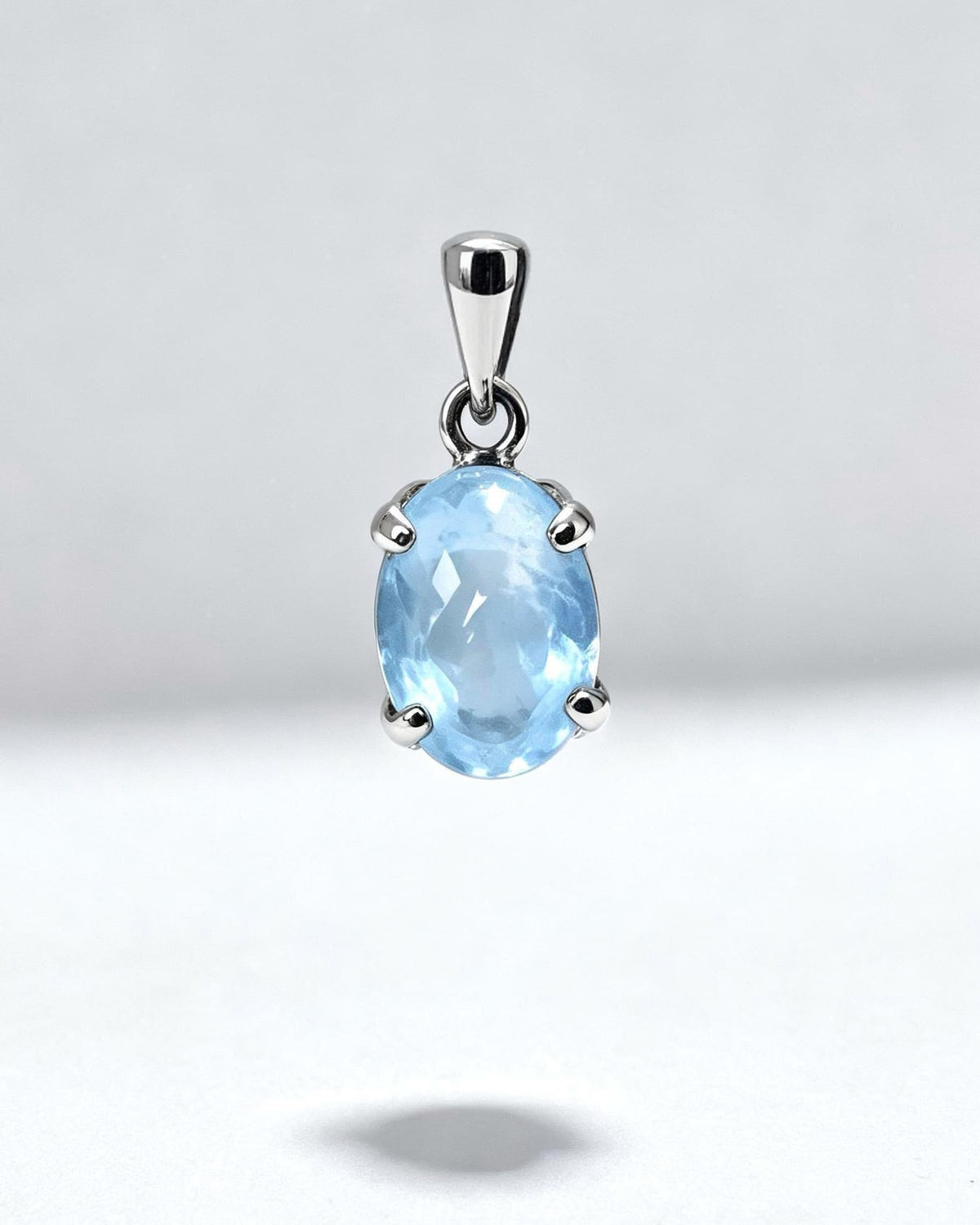 Blue Topaz Crystal Pendant – Oval Silver