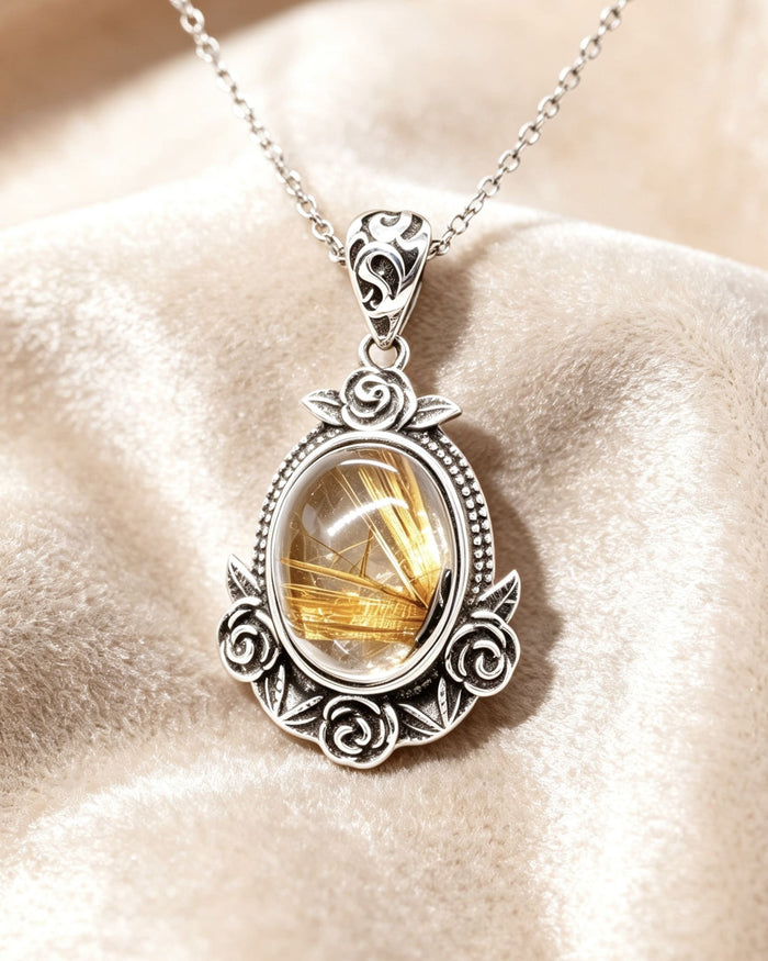 Silver pendant with a yellow gemstone on a beige surface